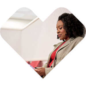 A CVS Health support agent wearing a headset, framed in a heart